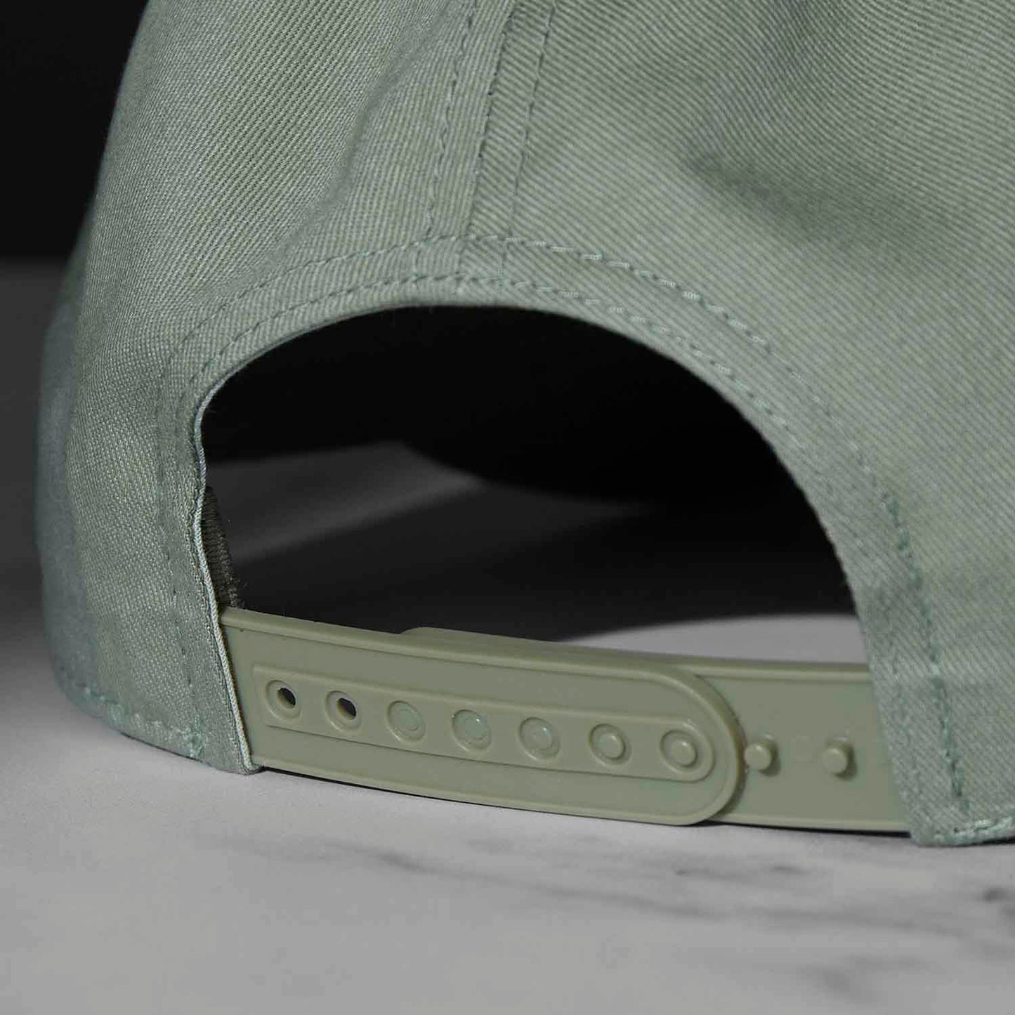 The adjustable closure of the Death Wish Coffee Thick Skull Snapback.