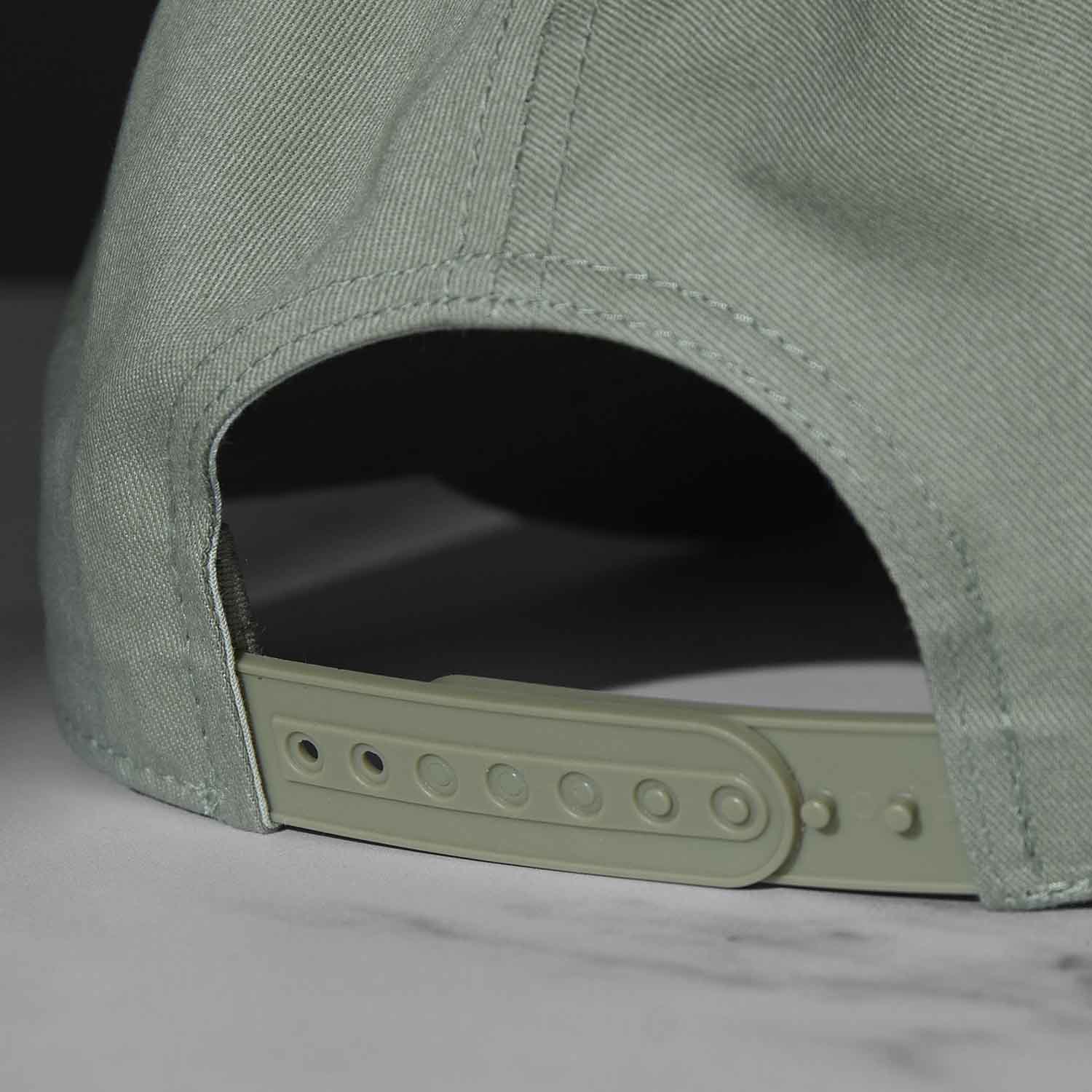 The adjustable closure of the Death Wish Coffee Thick Skull Snapback.