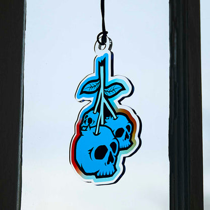 The Death Wish Coffee Blueberry Bliss Suncatcher hanging in a window.