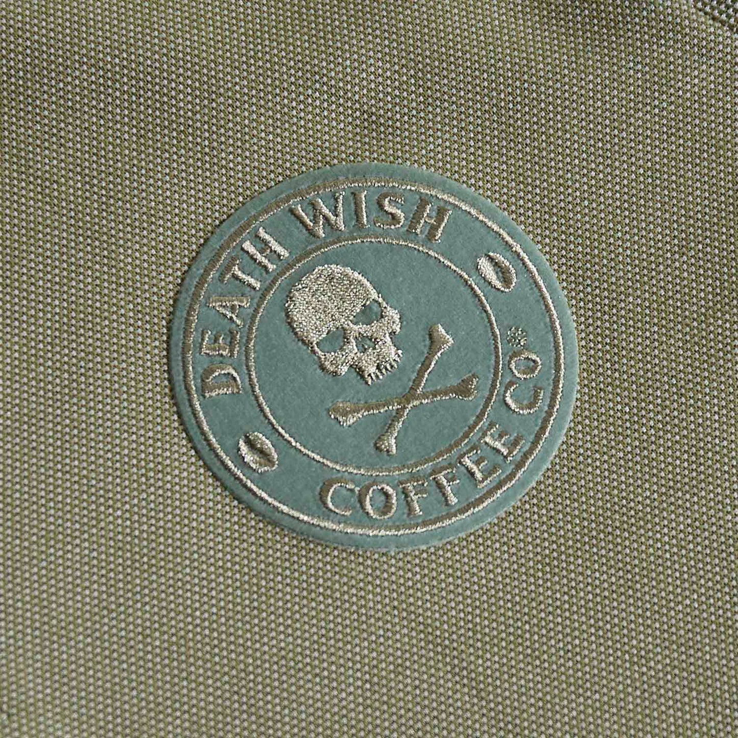 A detail shot of the front of the Death Wish Coffee Par For The Course Polo.