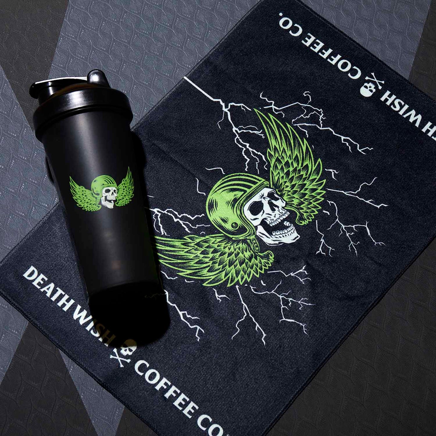 The Death Wish Coffee Blood, Sweat And Coffee Gym Towel next to the matching Shaker Bottle.