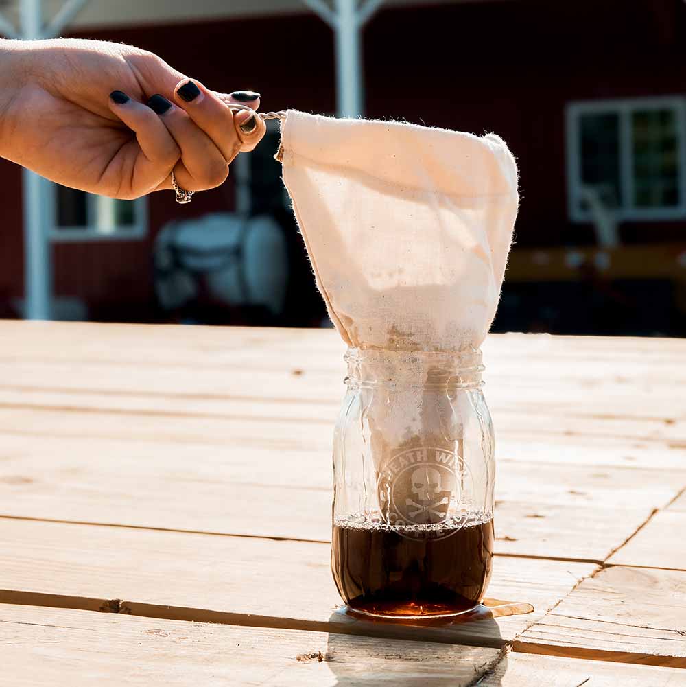 Making coffee on the go with a coffee sock and the Death Wish Coffee Etched Mason Jar.