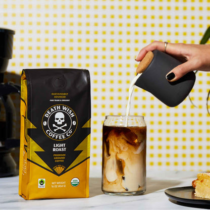 Pouring creamer into Light Roast Death Wish Coffee.