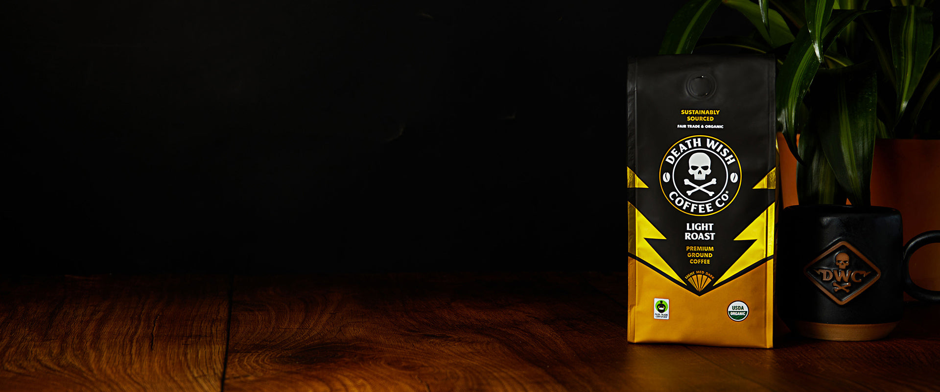 A bag of Light Roast Death Wish Coffee next to a mug.