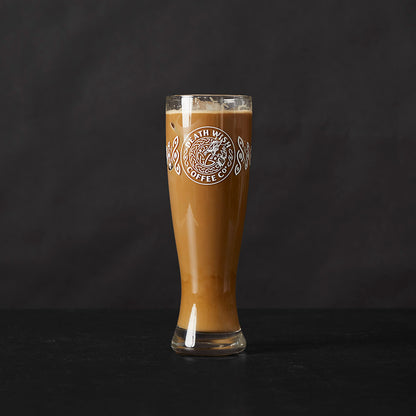 The Death Wish Coffee Dragon's Dawn Pint Glass Set filled with coffee.