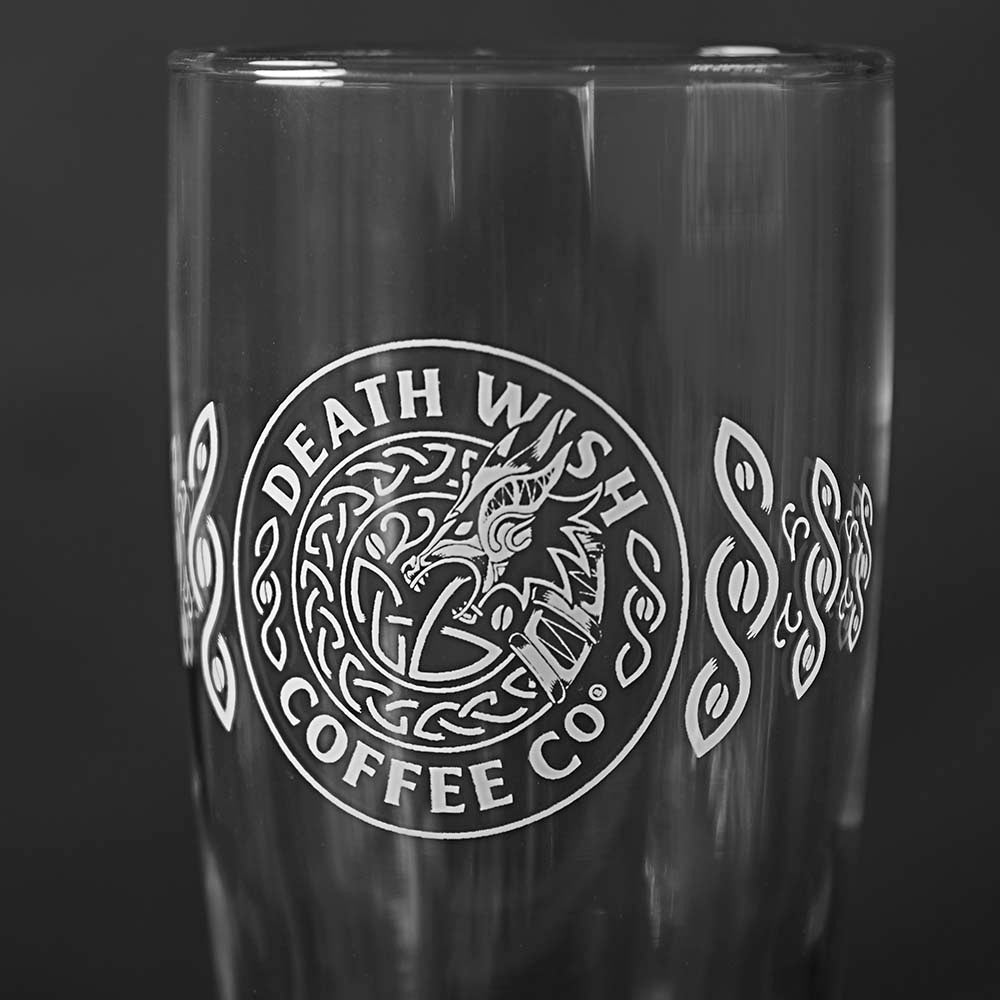 A close up of the etched logo of the Death Wish Coffee Dragon's Dawn Pint Glass Set.