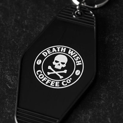 A close up of the back of the Death Wish Coffee Coffee, Road Trip, Repeat Keychain.