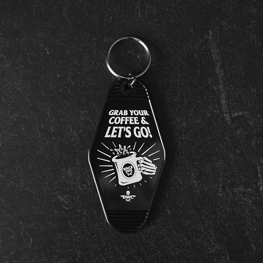 The front of the Death Wish Coffee Coffee, Road Trip, Repeat Keychain.