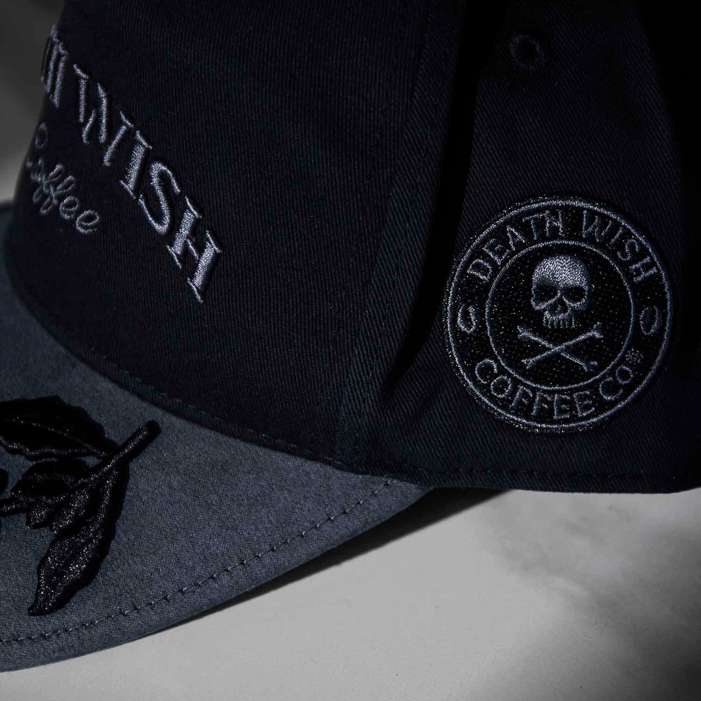 The side logo of the Death Wish Coffee Graveyard Shift Snapback.