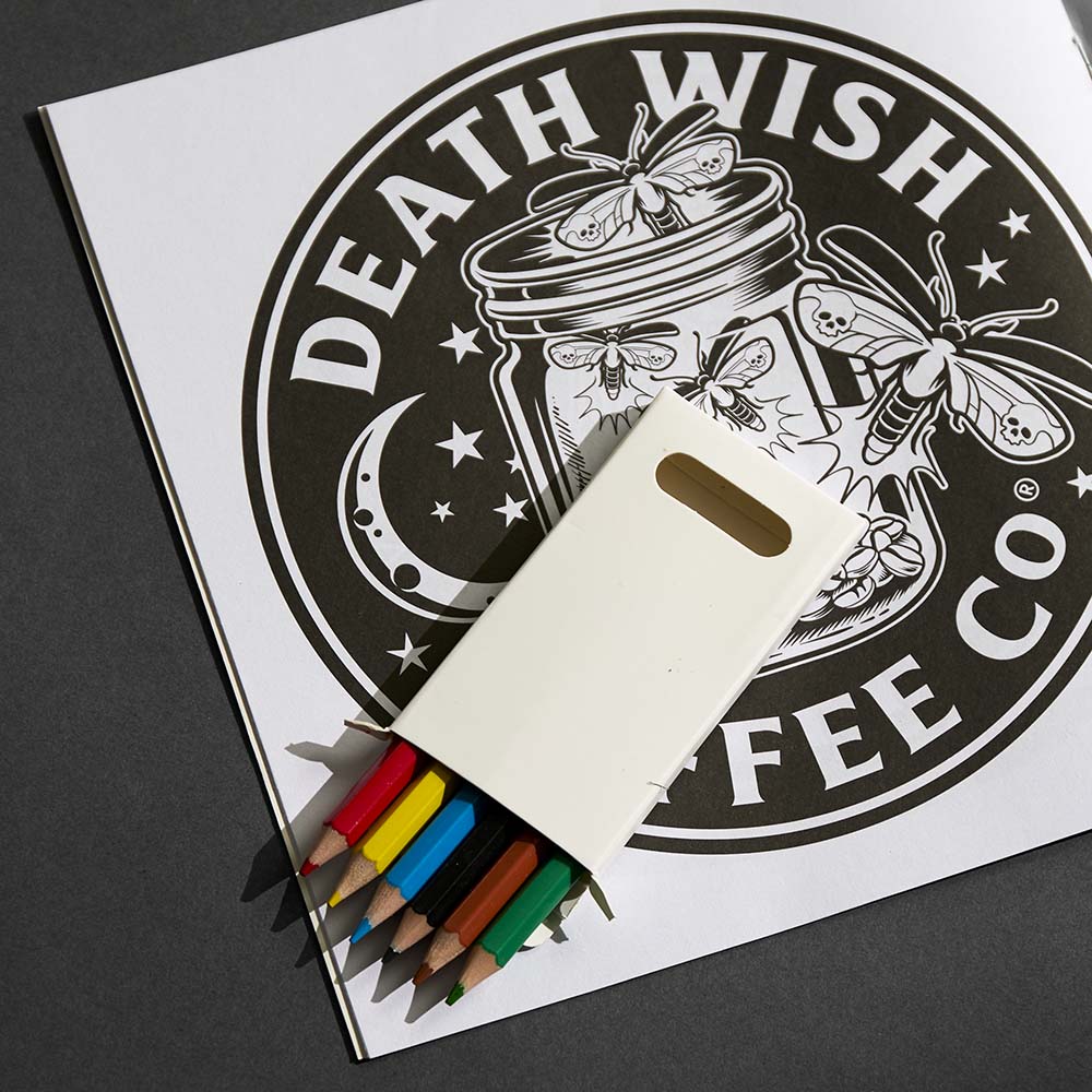 The Death Wish Coffee Medallion Meditations Coloring Book with colored pencils.