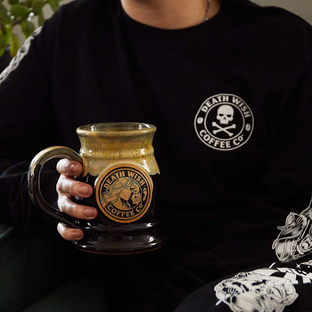 A model holding the Death Wish Coffee Two Faced Tankard.