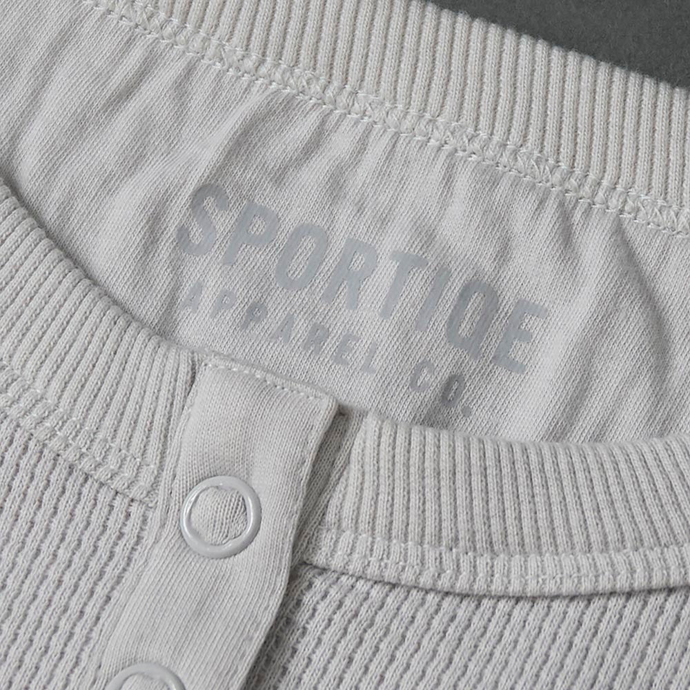 The interior neck label of the Death Wish Coffee Rolling Bones Women's Waffle Knit.