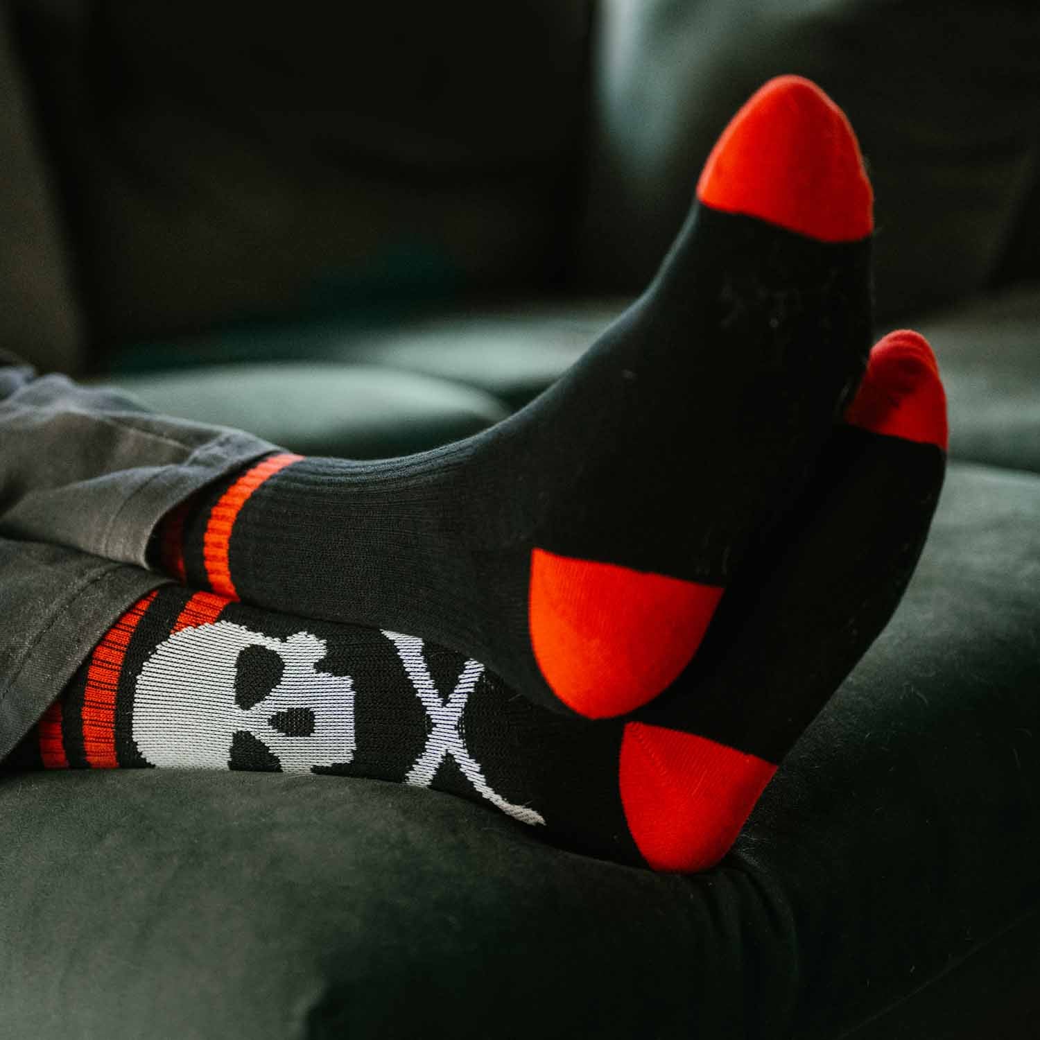 Feet up on the sofa in the Death Wish Coffee Classic Socks