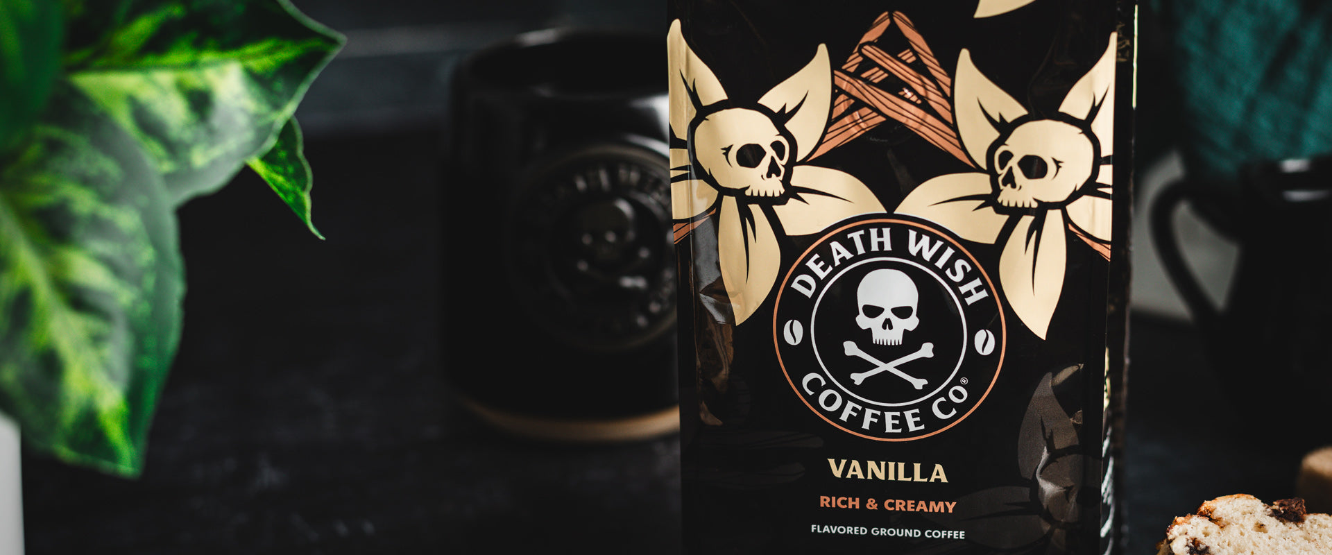 A bag of Vanilla Death Wish Coffee with a Death Wish Coffee mug in the background.